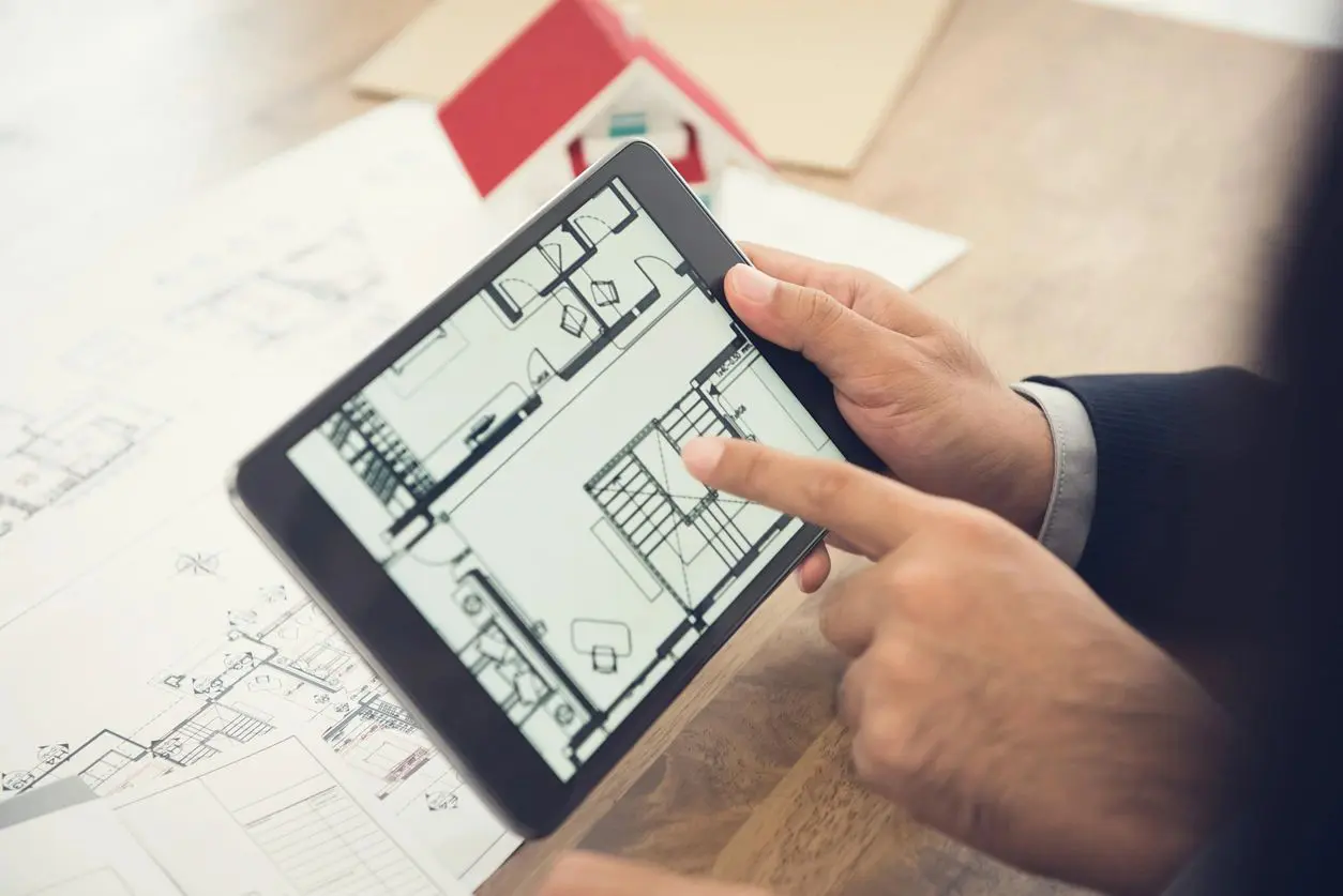 A person is using an ipad to plan their home.